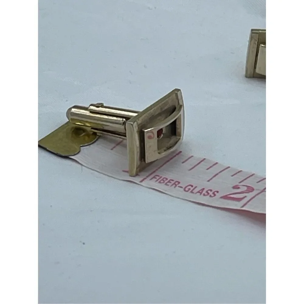 Vintage gold tone cufflinks with cut red glass crystals